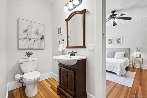 a spacious bathroom with a toilet sink and mirror