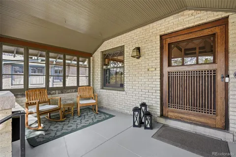 a dining room with furniture and a window