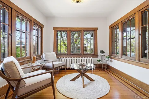 a living room with furniture and a floor to ceiling window