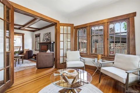 a living room with fireplace furniture and a large window