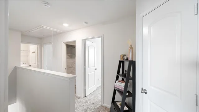a view of room with walk in closet and bathroom