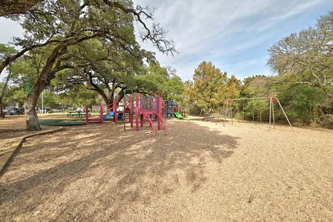 a view of outdoor space with playground and green space