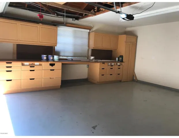 a kitchen with cabinets appliances and a counter