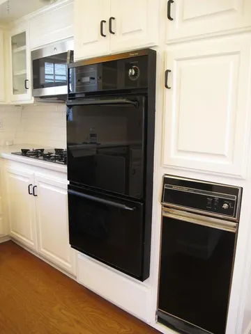 a kitchen with a stove and a microwave
