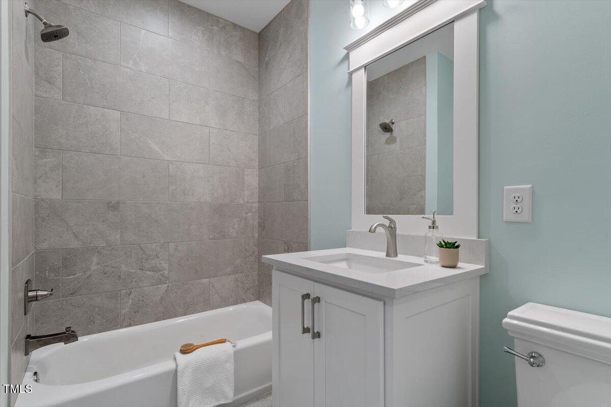 3932 Old Chapel Hill Road Durham, NC 27707 - Photo 37 of 46 a bathroom with a sink a toilet and bathtub