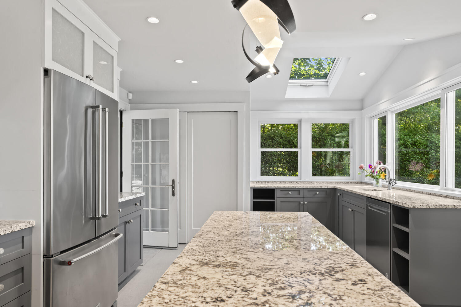 308 S Road Chilmark, MA 02535 - Photo 14 of 41 a large kitchen with kitchen island a large window a sink and stainless steel appliances