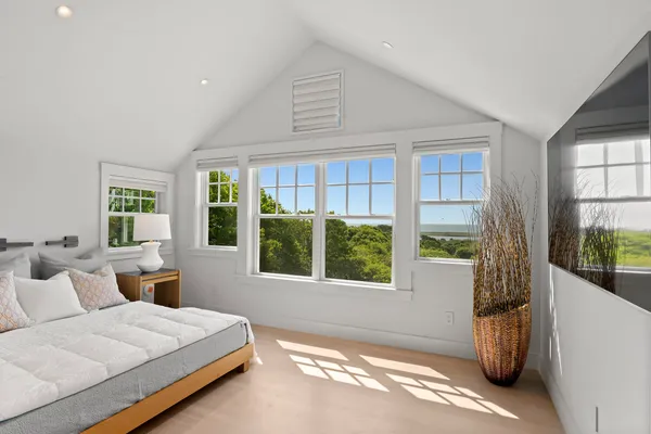 a bedroom with a bed and a television