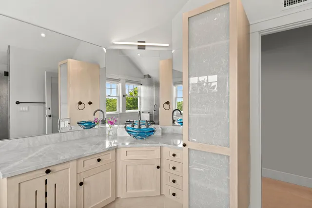 a bathroom with a granite countertop sink and window