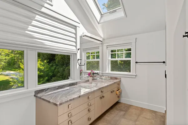 a living room with furniture and a floor to ceiling window