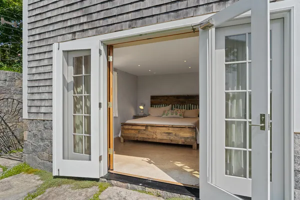 a bedroom with a bed and a window