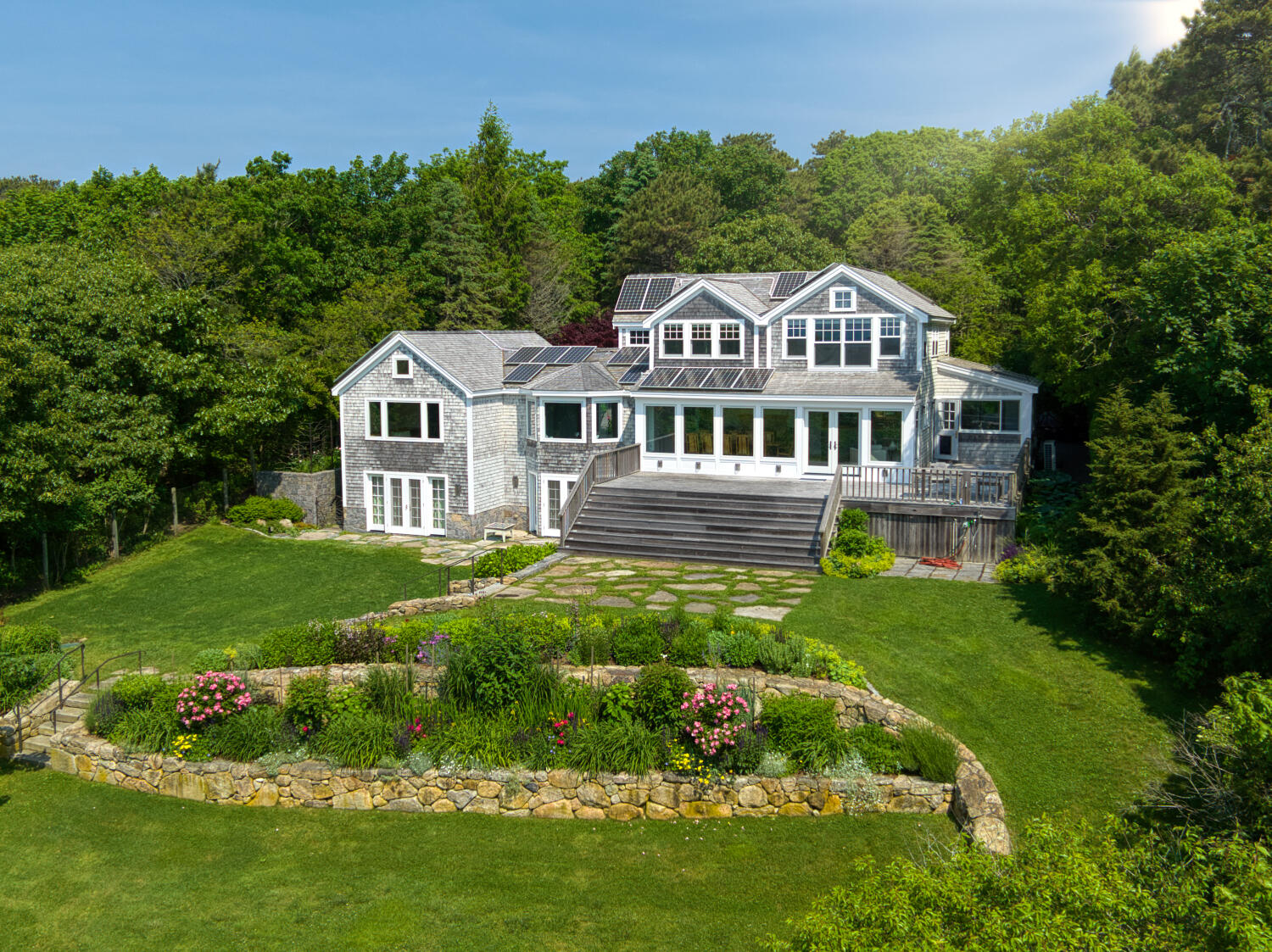 308 S Road Chilmark, MA 02535 - Photo 5 of 41 a front view of a house with a yard table and chairs