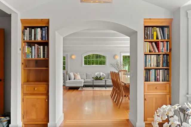 a living room with furniture and a book shelf