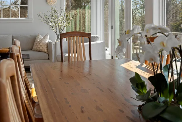 a dining room with furniture a rug and a large window