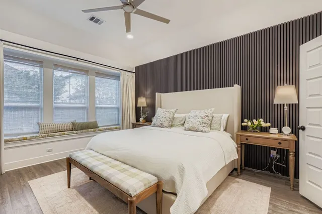 a bedroom with a large bed and a chandelier