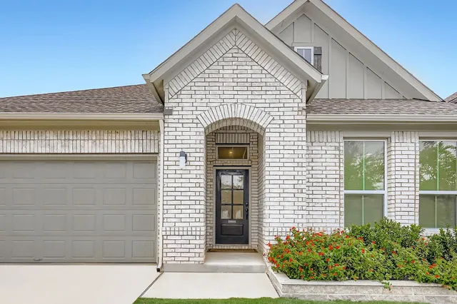 a view of a house with potted plants