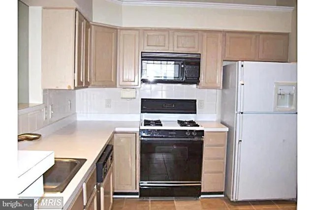 a kitchen with a stove and a refrigerator