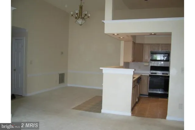 a utility room with cabinets washer and dryer