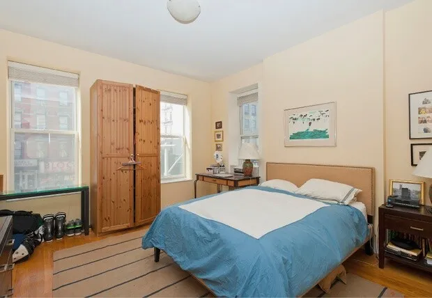 a bedroom with a bed and a table