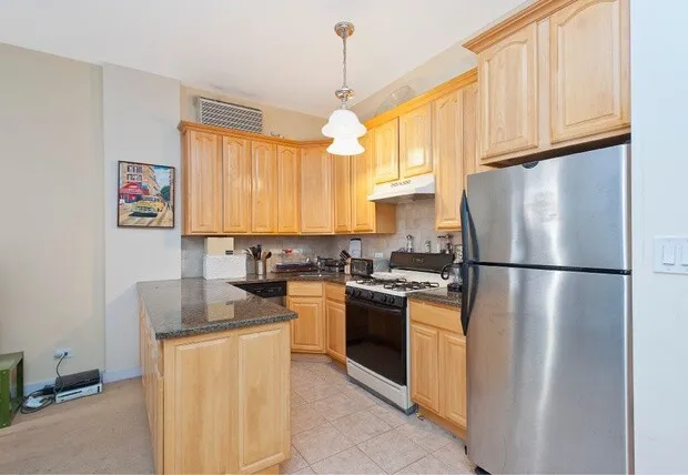 a living room with furniture a fireplace and a window