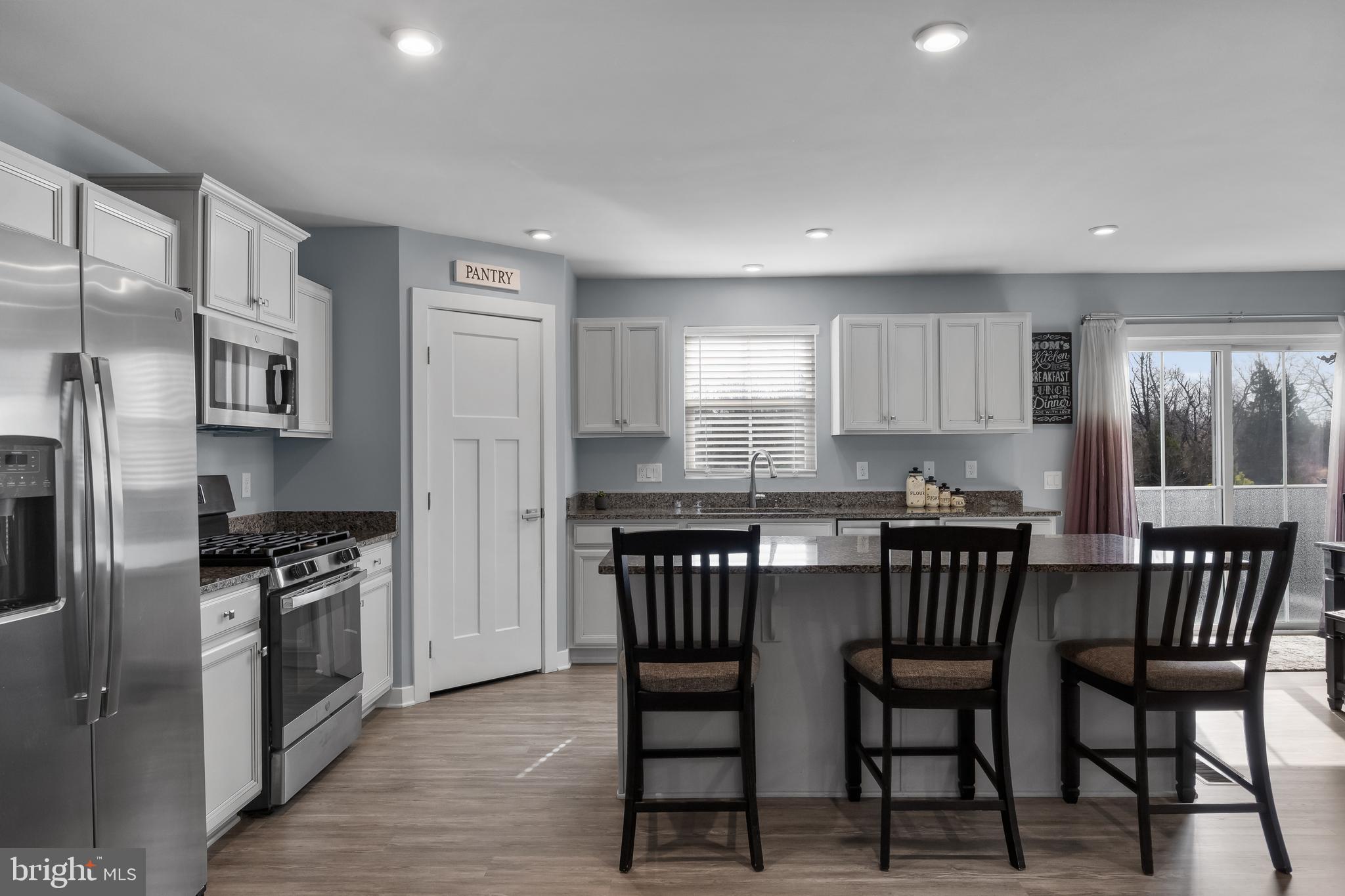 66 Senators Way Berlin, NJ 08009 - Photo 13 of 33 a kitchen with stainless steel appliances granite countertop a kitchen island hardwood floor and chairs