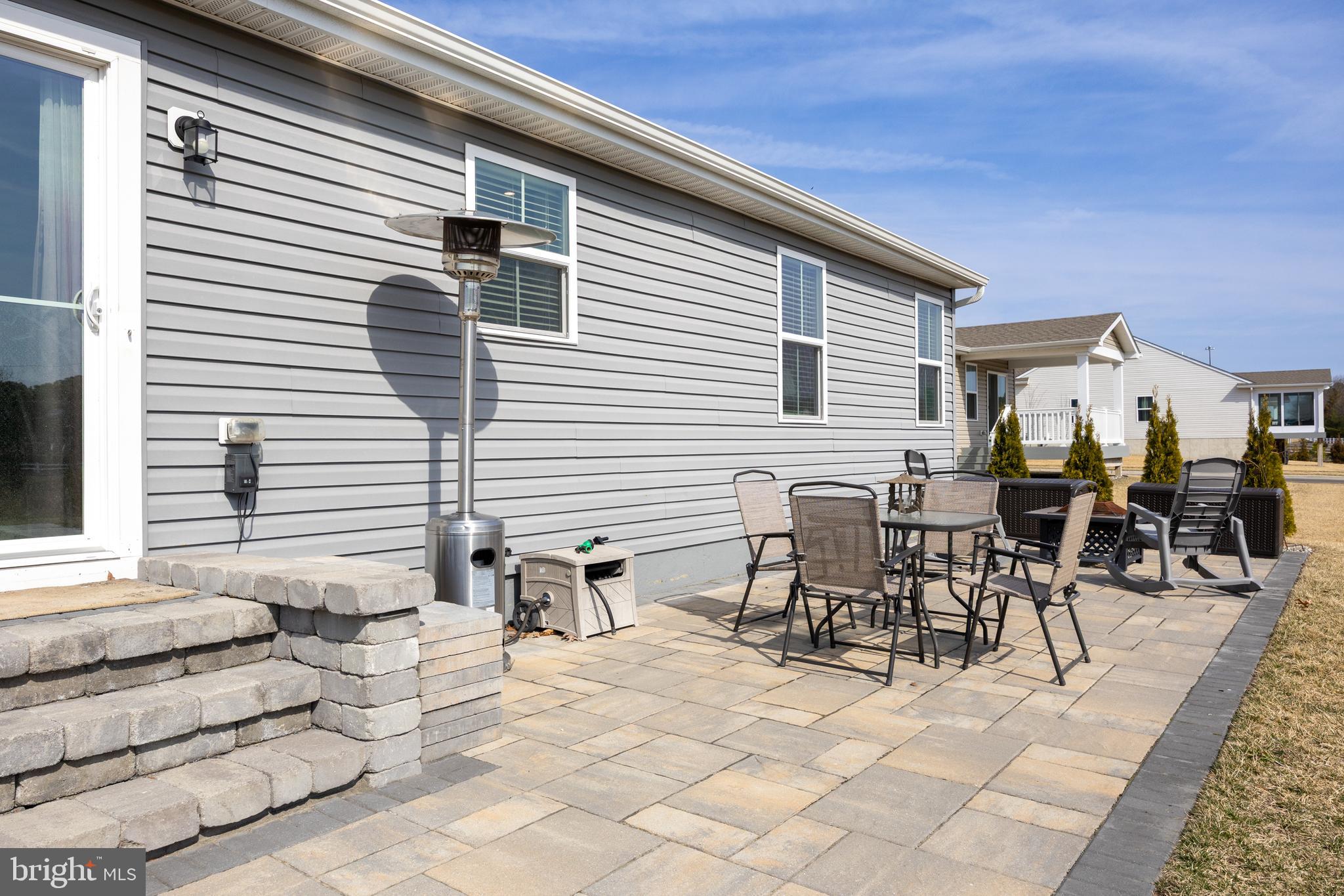 66 Senators Way Berlin, NJ 08009 - Photo 26 of 33 a view of a patio with table and chairs and wooden floor