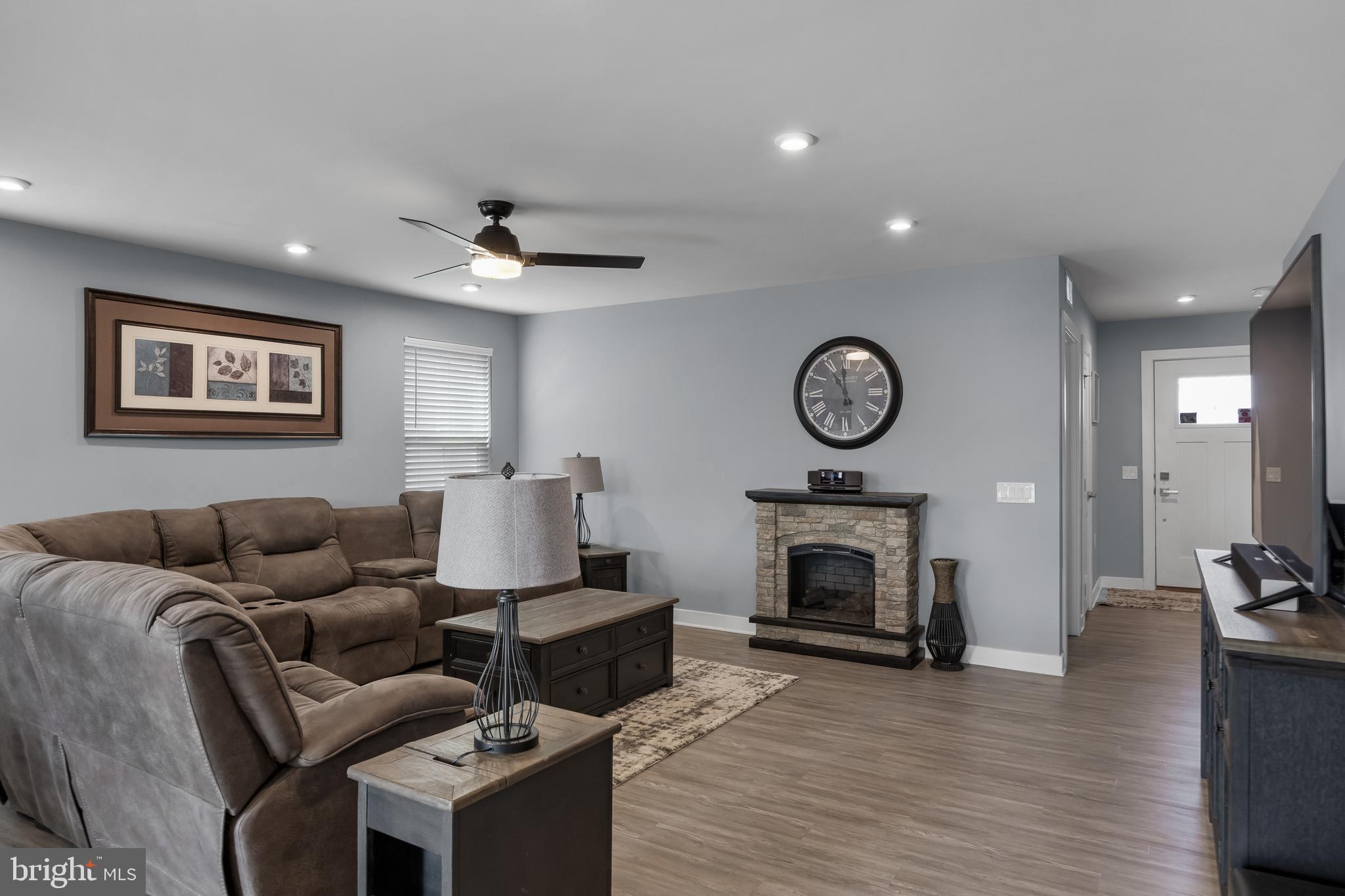 66 Senators Way Berlin, NJ 08009 - Photo 10 of 33 a living room with furniture a fireplace and a ceiling fan