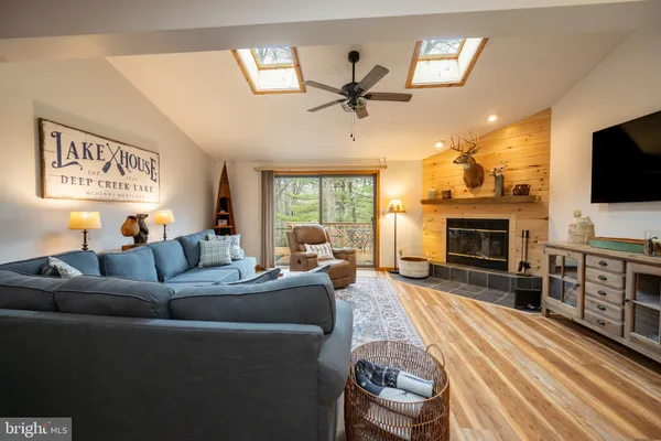 a living room with furniture a fireplace and a flat screen tv