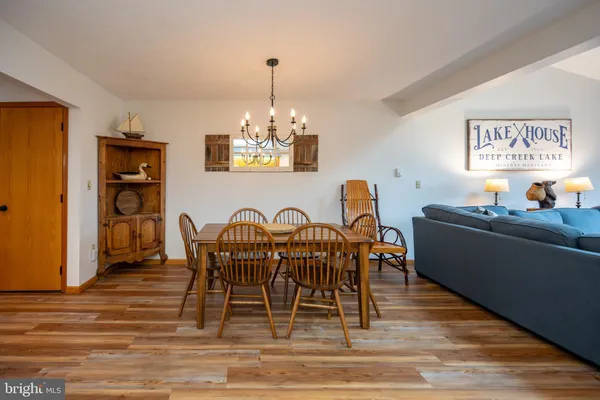 a view of a dining room with furniture and chandelier