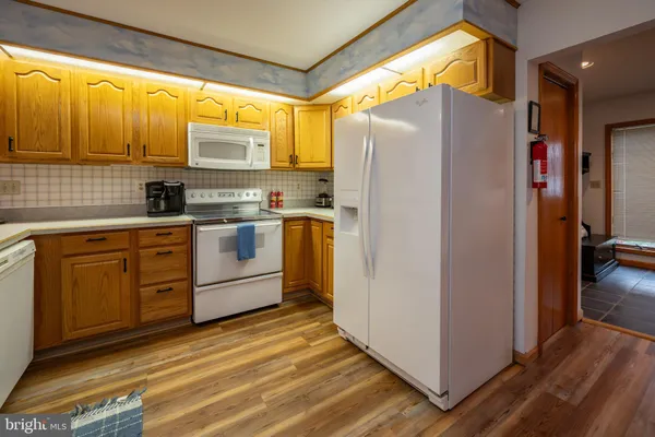 a kitchen with stainless steel appliances a refrigerator sink and cabinets