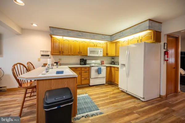 a kitchen with a sink appliances and cabinets