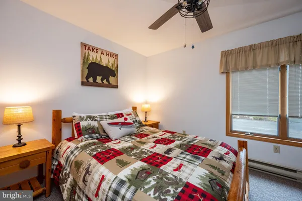 a bed room with a bed and a lamp