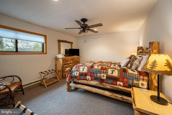 a bedroom with bed and a chandelier