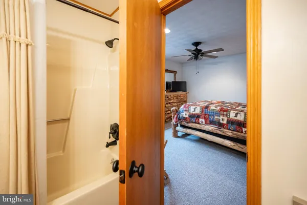 a bedroom with a bed and a shower