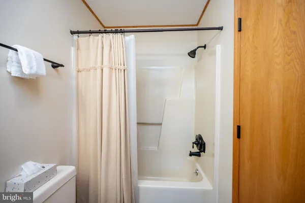 a bathroom with a shower and a bath tub