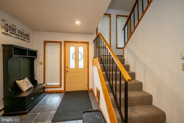 a view of entryway and hall with wooden floor