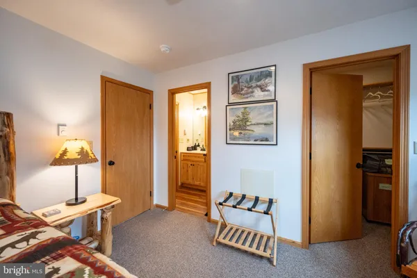 a bedroom with a bed and a lamp