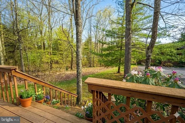 a view of a balcony with wooden floor and fence