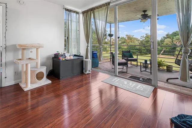 a living room with furniture and a floor to ceiling window