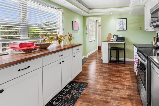a kitchen with sink cabinets and wooden floor