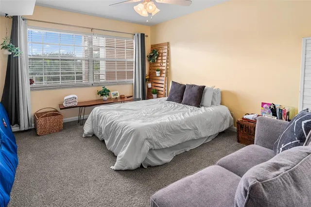 a bedroom with a bed and a large window