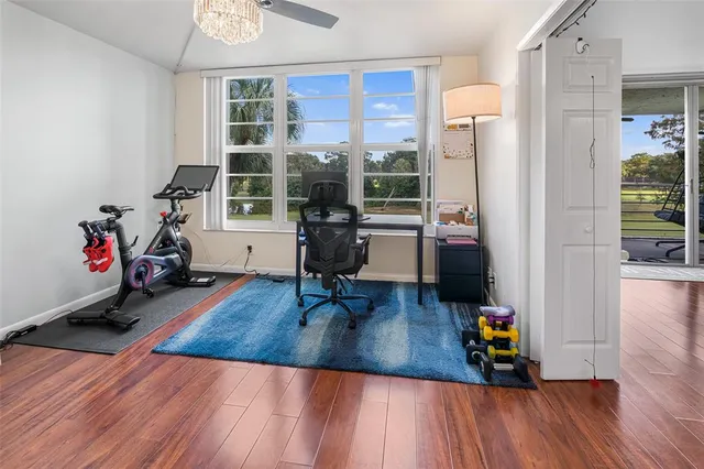 a living room with furniture and a floor to ceiling window