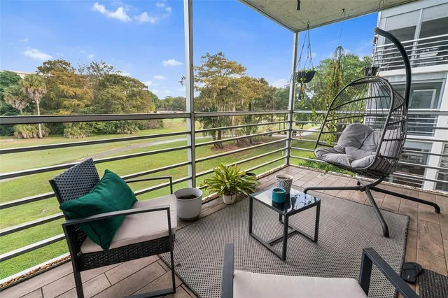 a view of a chairs and table in the balcony