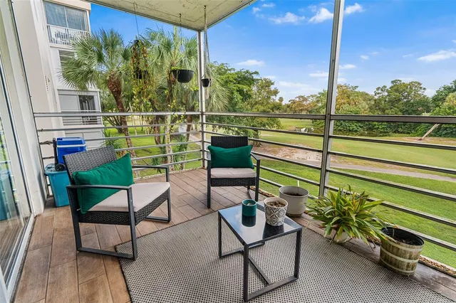a view of a chairs and table in a balcony