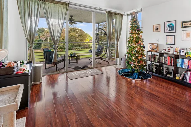 a dining room with wooden floor table and chairs
