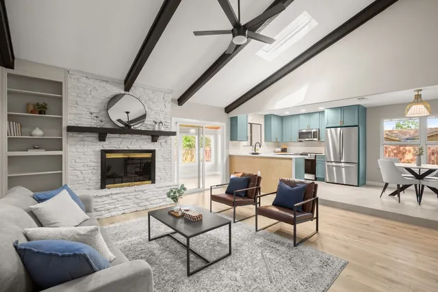 a living room with furniture a fireplace and a flat screen tv