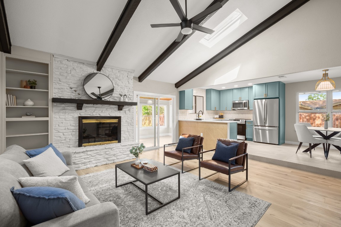 a living room with furniture a fireplace and a flat screen tv