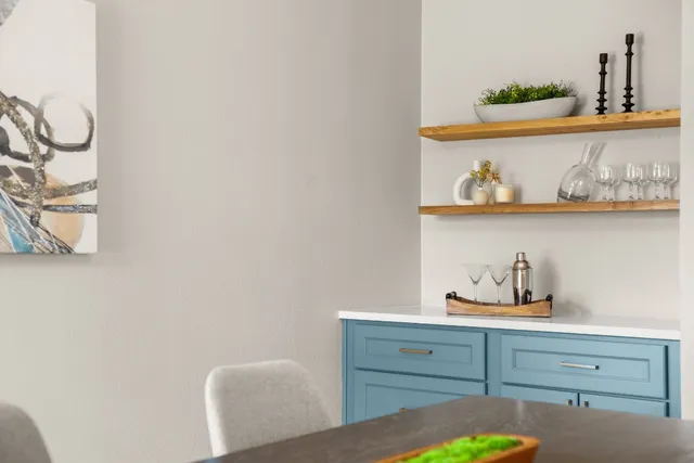 a kitchen with cabinets and wooden floor