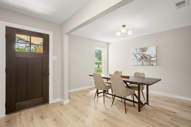 a view of a dining room with furniture and wooden floor