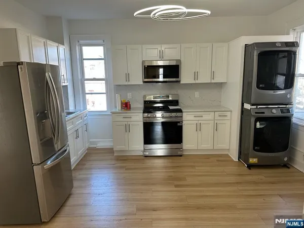 a kitchen with stainless steel appliances a stove a microwave and sink