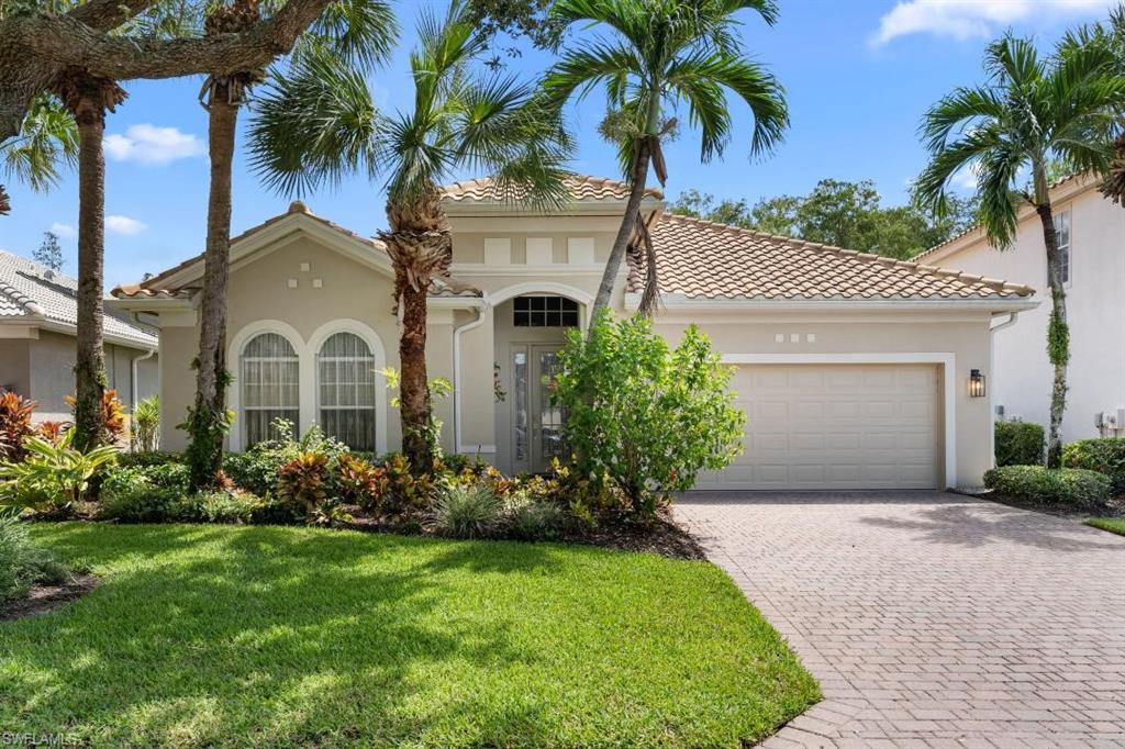 20117 Seadale Court Estero, FL 33928 - Photo 3 of 34 Mediterranean-style exterior with a tile roof, arched windows, and a paver driveway